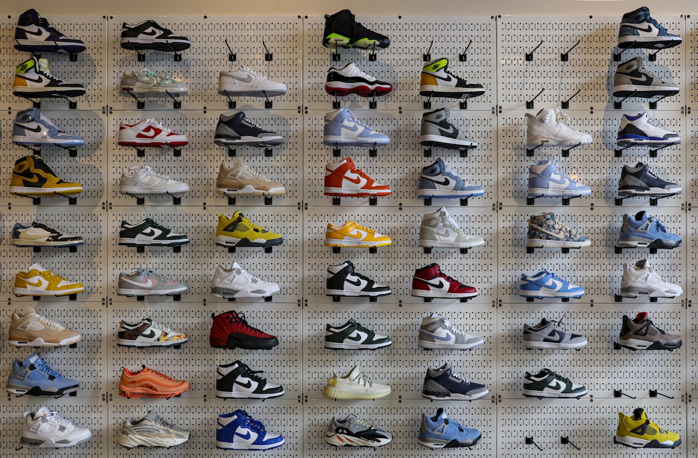 Sneakers displayed in a grid on a shoe-store wall